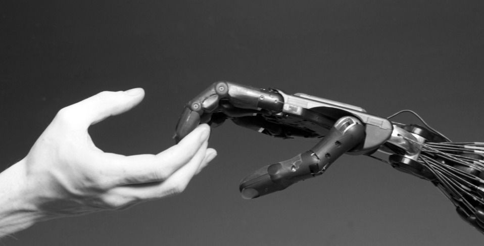 Robotic hand touching human hand